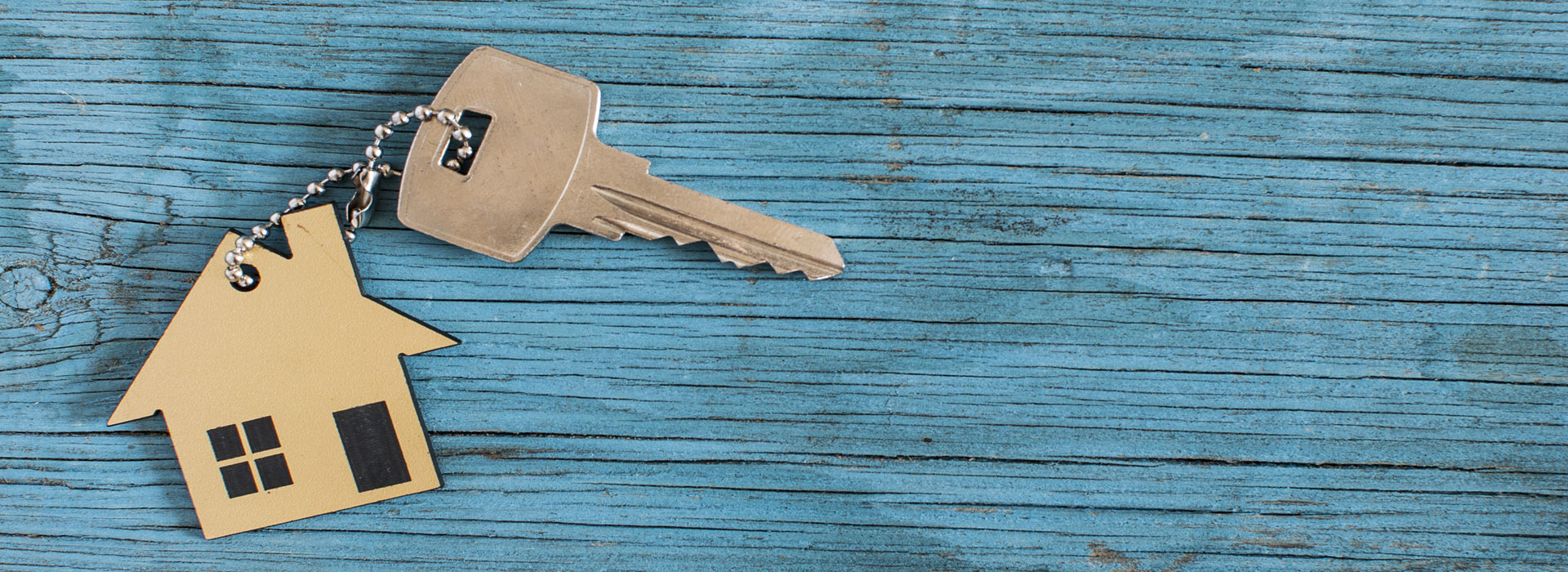 House keys on a blue painted wood surface